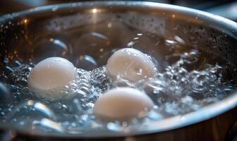 Eggs boiling in a pot of water, closeup view photo