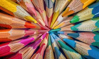 An overhead shot of colored pencils arranged in a pattern, abstract background with colored pencils photo