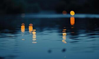 Bokeh lights reflecting off the surface of a calm lake at twilight photo