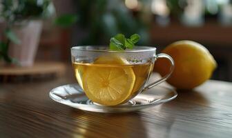 Bergamot tea and fresh lemon in a clear glass cup photo