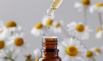 Chamomile essential oil in a dropper bottle, closeup view, skin care cosmetic background photo