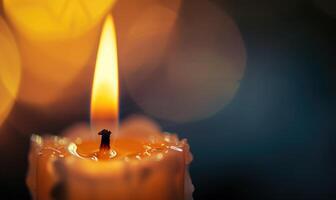 Close-up of a candlewick glowing brightly amidst the darkness photo