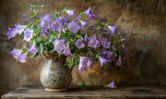 Bellflower bouquet in a rustic vase photo