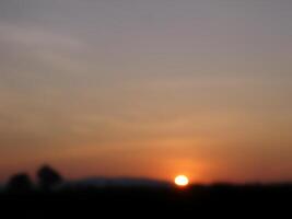 Spectacular sunset over, orange sun rising up over the horizon photo