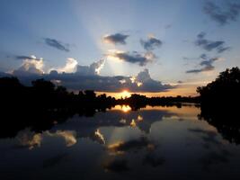 Spectacular sunset over, orange sun rising up over the horizon photo