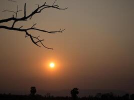 Spectacular sunset over, orange sun rising up over the horizon photo