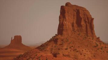 A large rock formation in the middle of a desert video