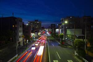 A traffic jam at the street in Setagaya Tokyo at dusk wide shot photo