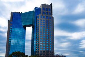 A cloud reflecting an impressive building cloudy wide shot photo