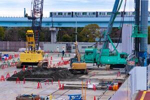 Cranes at the under construction near the railway telephoto shot photo