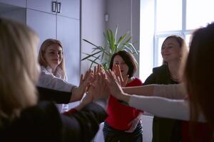 team members in the office congratulate each other on a good job and the completion of the project photo