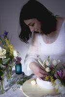 female florist make decorations and floral arrangements for Easter photo