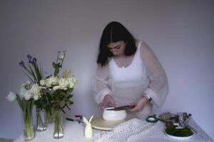 female florist make dekorations and floral arrangements for easter photo