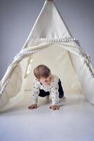 toddler playing in a tent in a minimalist style photo