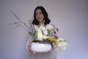 female florist make decorations and floral arrangements for Easter photo