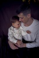 dad kisses and hugs his little son photo