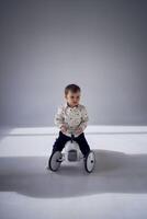 A toddler is enthusiastically playing with his toy car on his birthday photo