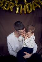 dad kisses and hugs his little son photo