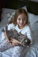 girl plays with a cat photo