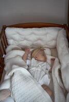 baby sleeps in a cradle photo