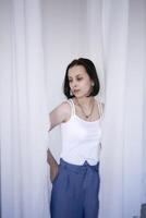 young teenage girl fighting brain cancer in a studio photo shoot, white curtains surround the girl, purity, innocence, minimalism