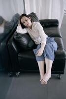 young teenage girl fighting brain cancer at photo shoot in studio, metal wall, reflection, black sofa