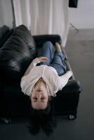 young teenage girl fighting brain cancer at photo shoot in studio, metal wall, reflection, black sofa