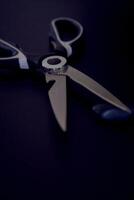 kitchen scissors with a jagged blade on a black background photo