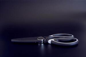 kitchen scissors in a protective case on a black background photo