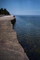 a concrete embankment and transparent sea water photo