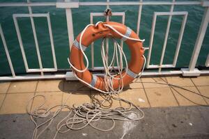 lifebuoy with a rope on the pier photo