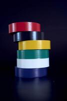set of colored insulating tape on a black background photo