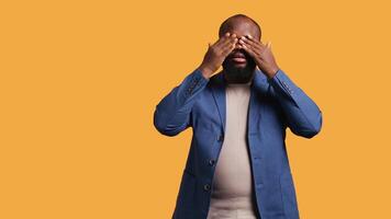 African american man covering eyes, ears and mouth with hands, imitating the three wise monkeys. BIPOC person doing don t see, don t hear and don t speak gesturing concept, studio background, camera B video