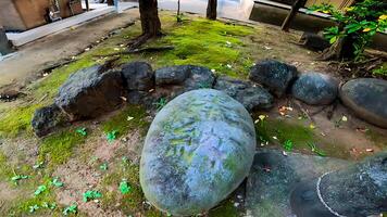 A force stone used for strength contests. In the old days, people lifted this stone during festivals to compare strength. photo