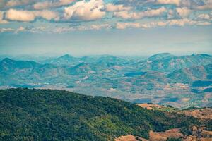 The stunning view in Forest Park from a tourist's standpoint as they go down a hill with background of blue sky, Rainforest, Thailand. Bird's eye view. Aerial view. photo