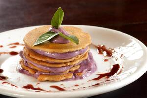 pancakes with grape jelly cream on plate photo
