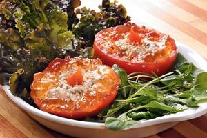 leafy salad with tomatoes stuffed with red pepper jam photo