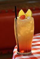 Planter's Punch, classic drink with Jamaican rum, lemon, orange, grenadine, angustura, pineapple and ice photo