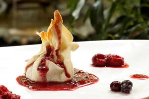 dough bundle with red fruits and cherry jam photo