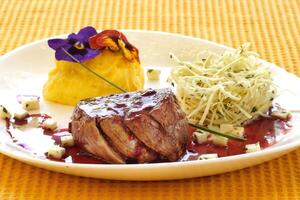 grilled tall fillet with cassava puree and grape jelly sauce photo