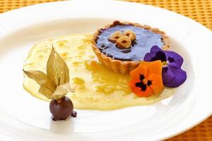 Chestnut tartlet with grape jelly and apricot jelly topping photo