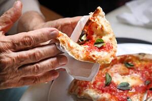 step-by-step guide on how to eat authentic Neapolitan pizza with your hands photo