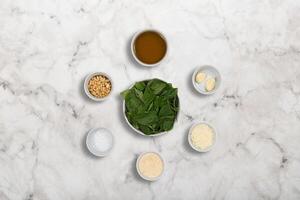 step by step of Italian pesto sauce, with fresh basil, walnuts and grated parmesan cheese. photo