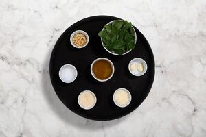 step by step of Italian pesto sauce, with fresh basil, walnuts and grated parmesan cheese. photo