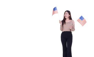 Young woman holding an American flag with a white background. Space for Text. 4th of July. Celebrate American National Day. Labor Day. Independence Day and more photo