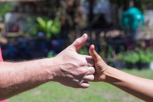 Close-up of hands man and woman showing signals of success and good photo