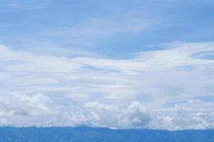 Scenic view of clouds cover mountains with the sky background photo