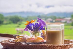 Close-up of fruit set and soybean milk on a plate on a wooden table with nature background. Snack set for after breakfast. Concept of foods healthy photo