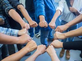 Close-up of many people hands in a circle together with sunlight effect. Concept of teamwork photo