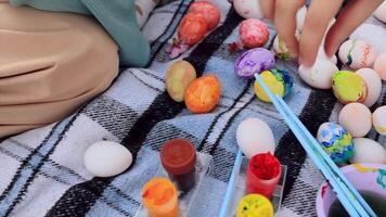 coloring Easter eggs with colorful paints. Religion and traditions. Easter celebration. Process of making handmade painted Easter eggs video